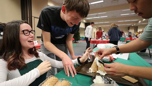 students work on their gingerbread house creation